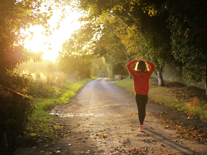 woman doing morning walk in sunrise to reset circadian rhythms