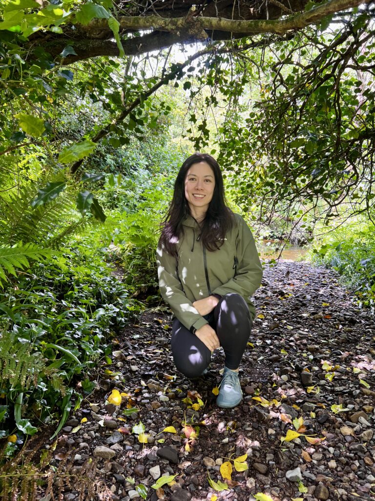 Woman crouching down in the forest