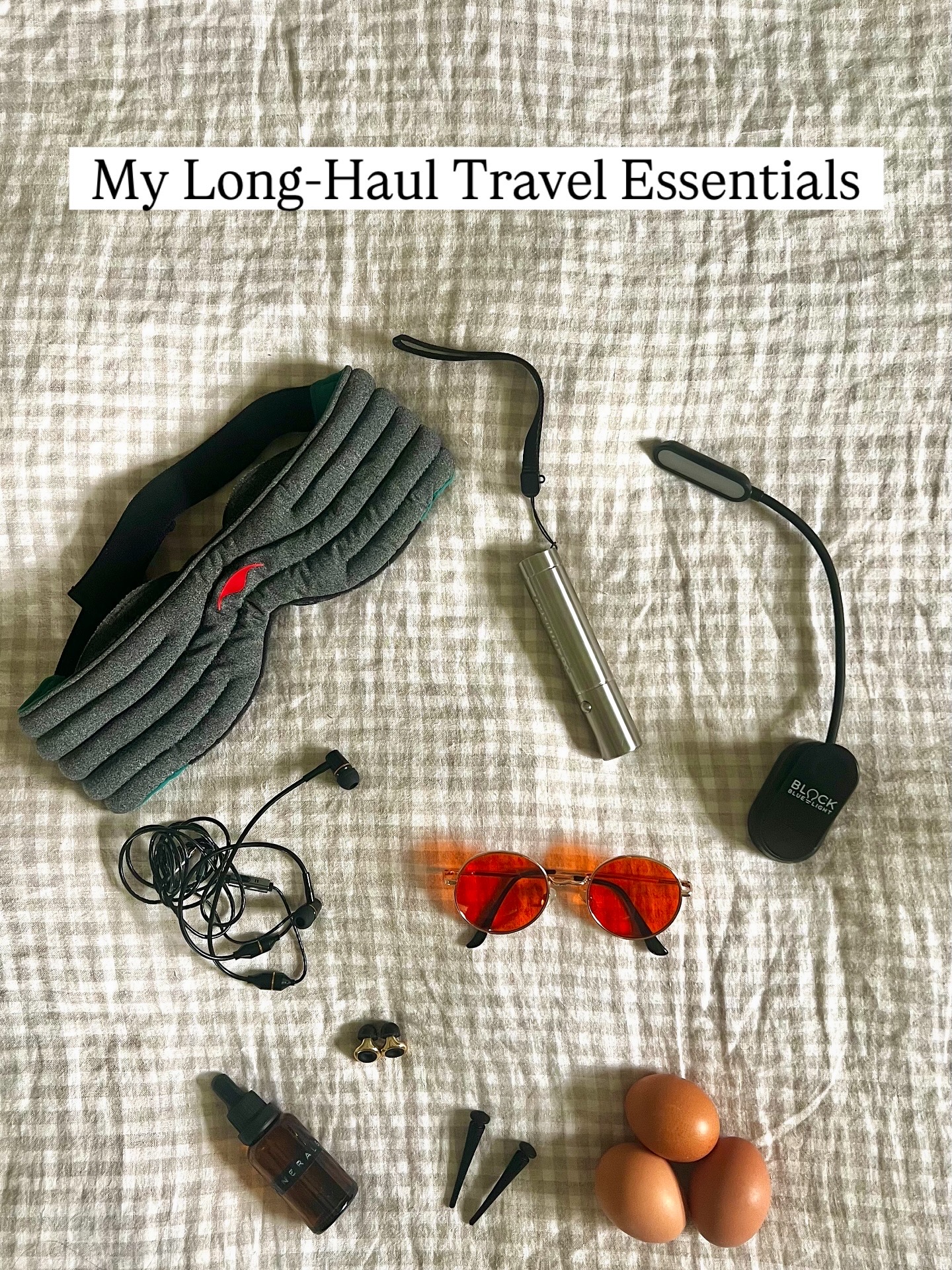 several travel essential items laid out on a bed