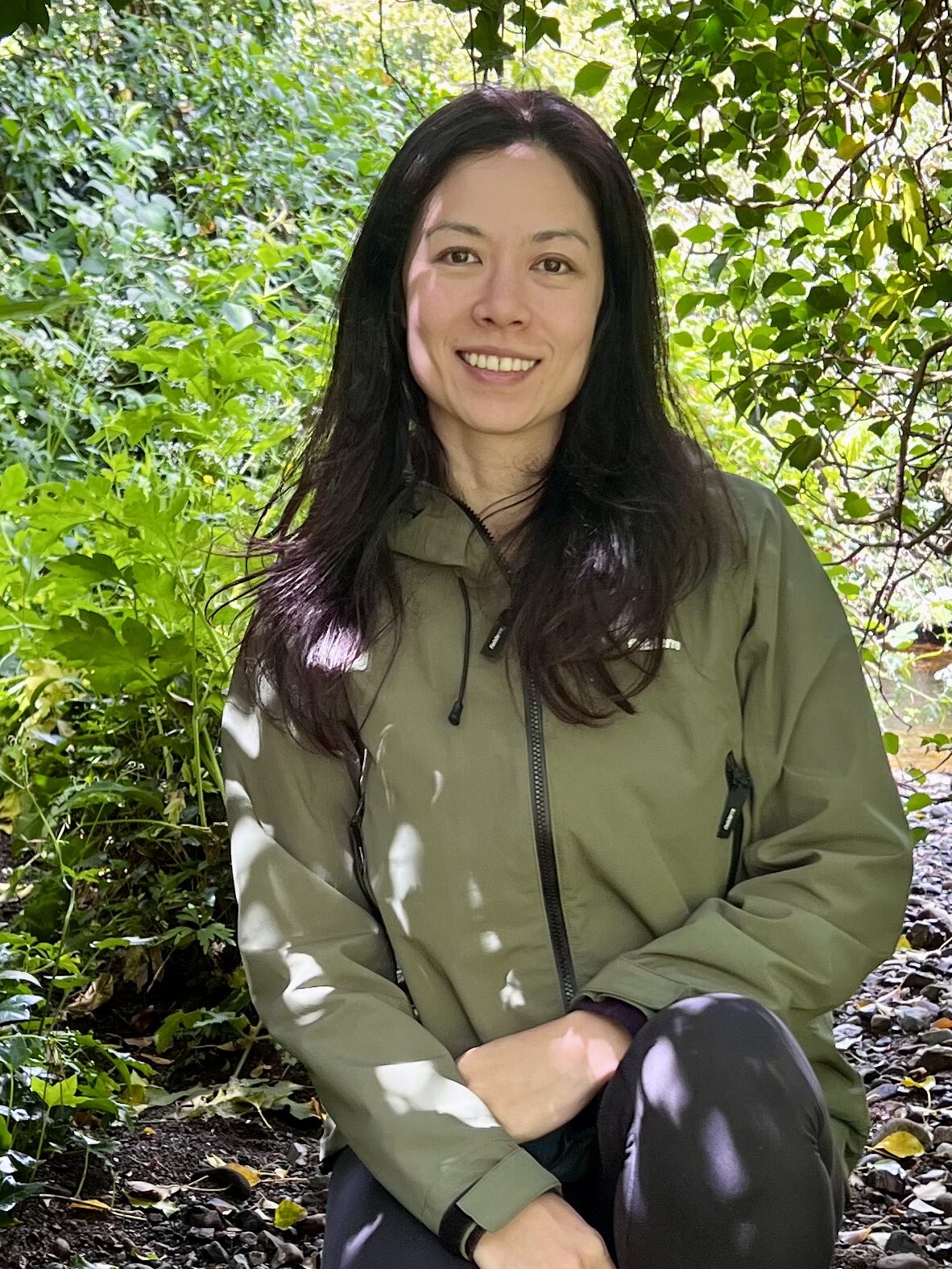 Woman crouching down in the forest